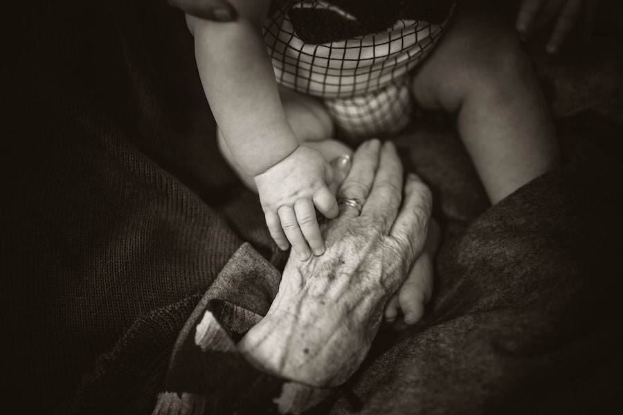 Grandmother and grandchild holding hands